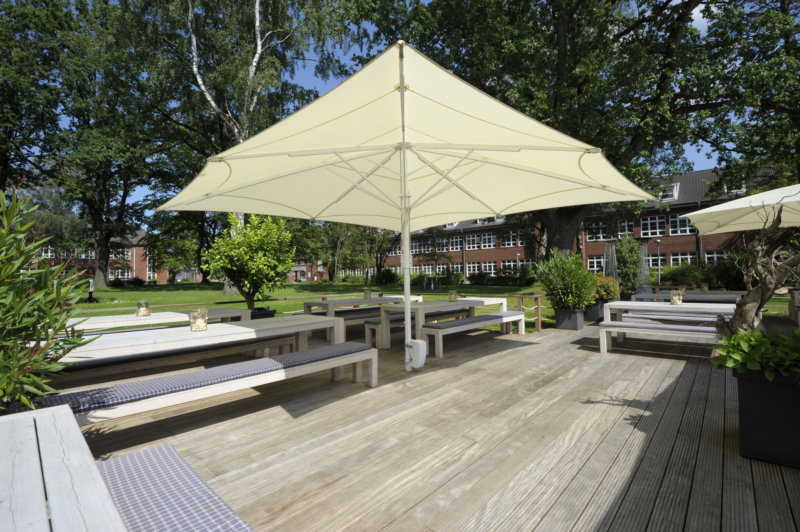 Weißer Bahama Jumbrella Großschirm über der Holzterrasse des Restaurant Marlin